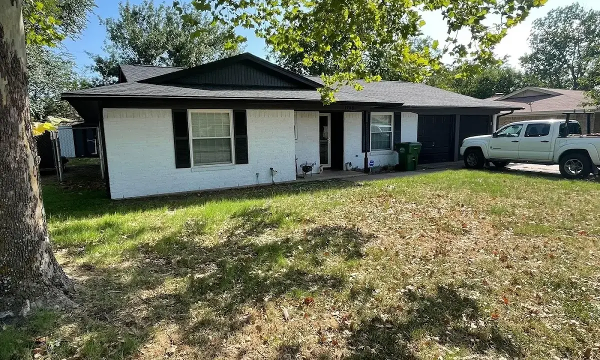 Professional roofing crew working on a residential roof in Tulare